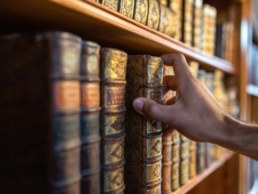 Man Holding Book In Library
