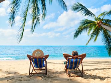 Couple relax on the beach enjoy beautiful sea on the tropical island. Summer beach vacation concept