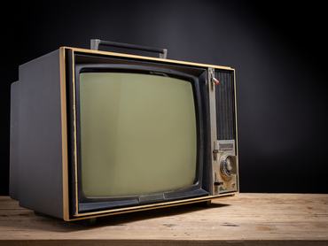 Retro old TV on wooden in dark background, stack photos, vintage tv with copy space