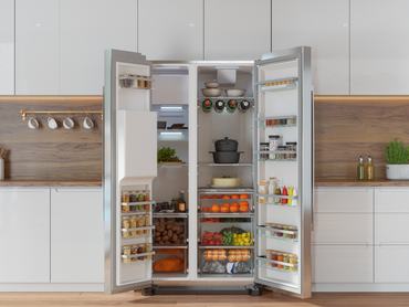 Modern Kitchen Interior With Front View Of Open Refrigerator Filled With Fruits, Vegetables And Various Foods
