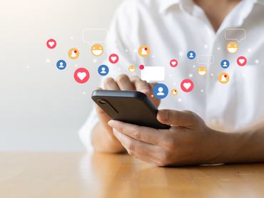close up man hand hold smartphone and use social media network application to connect or interact with people and friend on online platform with virtual icon symbol for modern lifestyle and communication concept