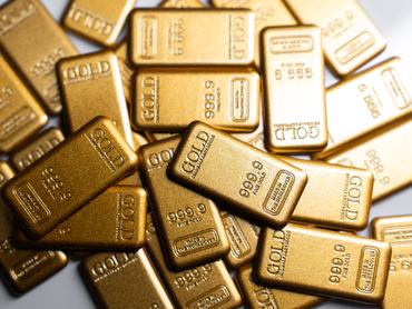 Pile of gold bars closely packed symbolizing precious metal investment and wealth storage.