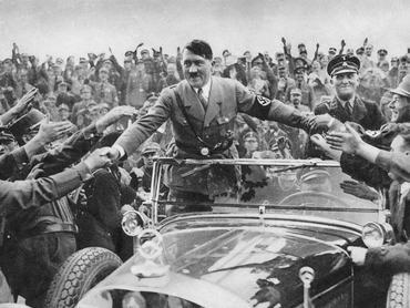 1933: Adolf Hitler (1889 - 1945), chancellor of Germany, is welcomed by supporters at Nuremberg. (Photo by Hulton Archive/Getty Images)