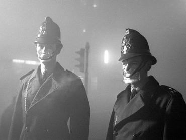 PC John Finn (right) from Snow Hill Police Station with a colleague. Both wear smog masks. Smog affected London up until the mid 60s when the clean air act finally caused London's Pea Soupers to be a thing of the past. 6th December 1962. (Photo by Alisdair MacDonald /Daily Mirror/Mirrorpix via Getty Images)