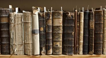400 year old antique books in a library. Photo was taken at avaible light, for accurate representation of the atmosphere inside.